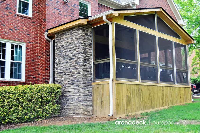 screen porch addition with stone fireplace